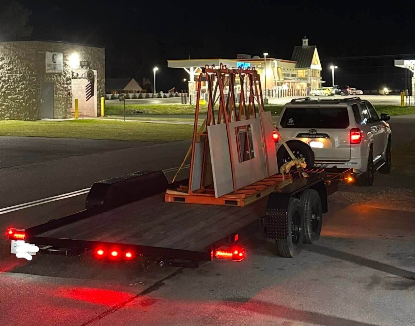 Salty Hands flatbed trailer loaded with a secured stone slab delivery